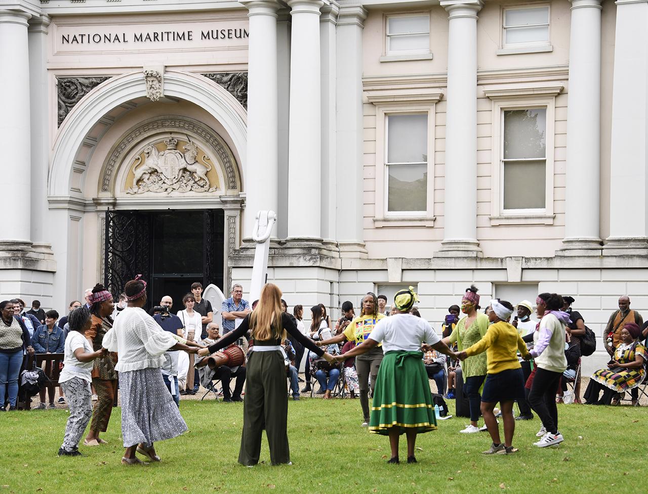 An image showing 'People dancing outside the National Maritime Museum'