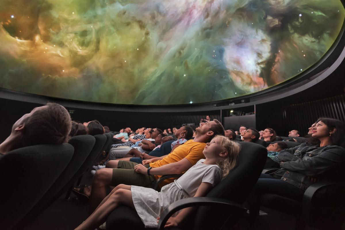 People watching planetarium show
