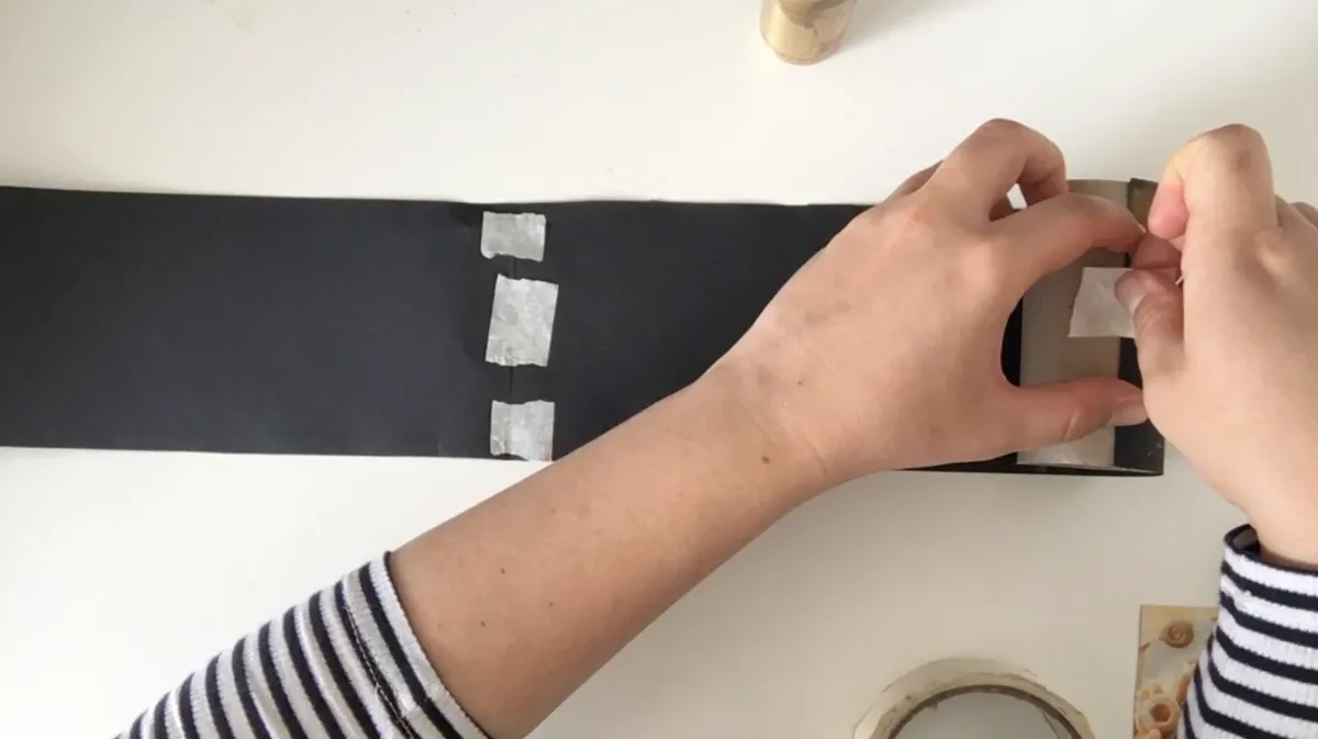 Securing end of drawing to toilet paper roll