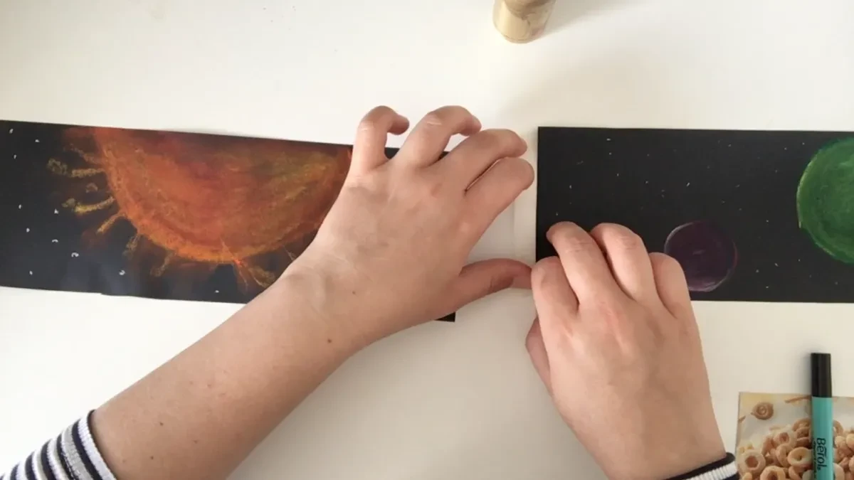 Sticking pieces of black paper together