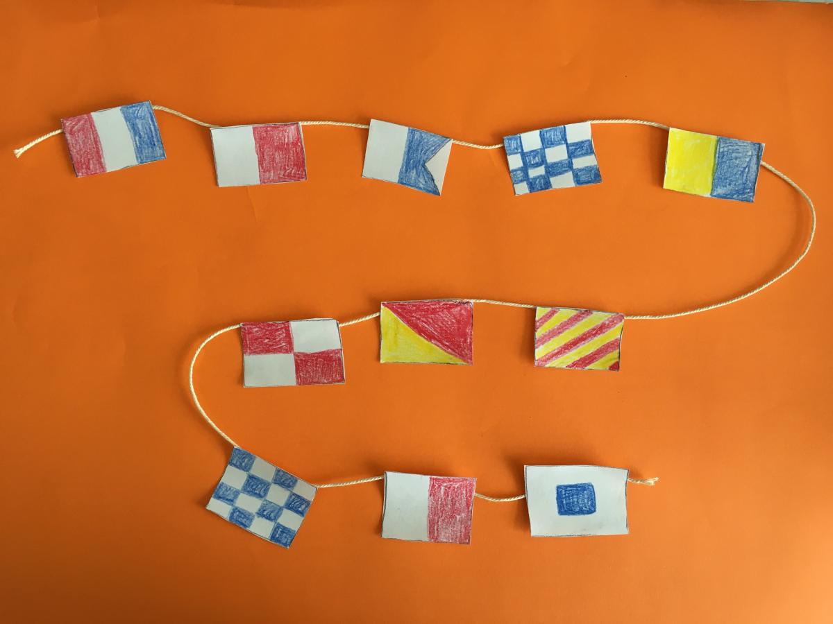 hand drawn signal flag message on a string