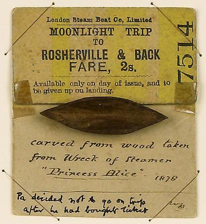 A small wooden boat attached to a ticket. The note reads, 'Carved from wood taken from wreck of steamer Princess Alice'
