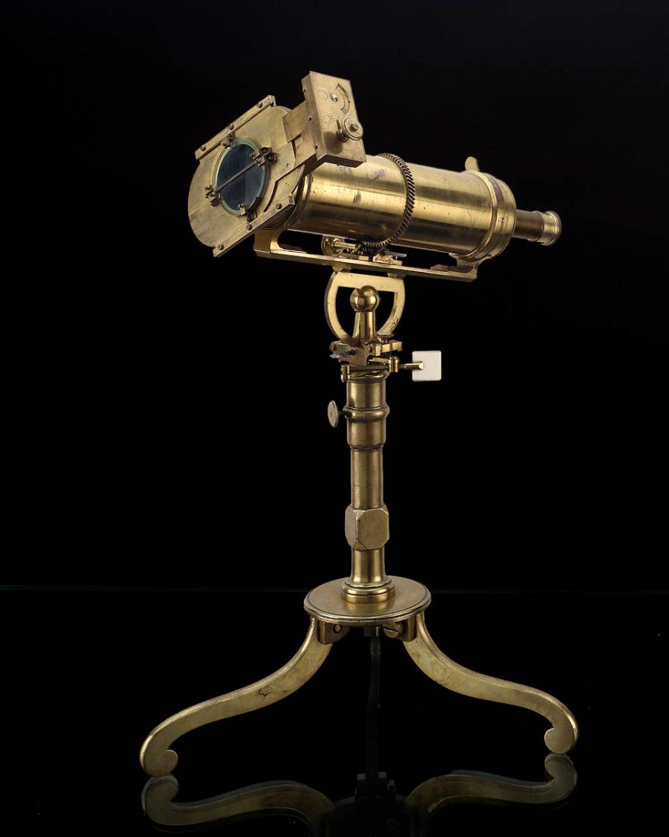 A gold heliometer on a stand