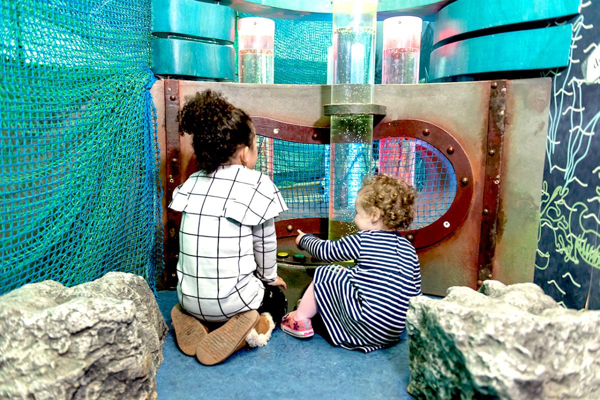 Two young children play in the family-friendly AHOY! Gallery at the National Maritime Museum