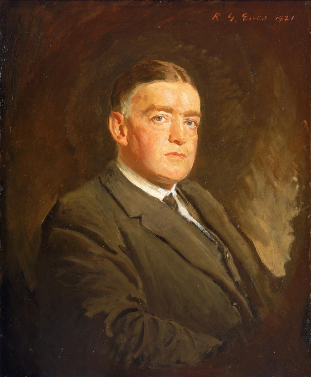 A portrait of polar explorer Ernest Shackleton. The sitter wears a brown suit, waistcoat, white shirt and dark tie, and looks forwards to meet the gaze of the viewer