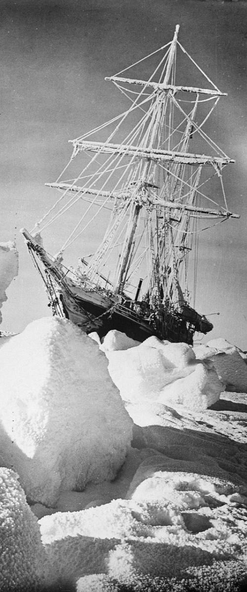 A black and white historic photograph of the ship Endurance stuck in the ice during Shackleton's expedition to the Antarctic