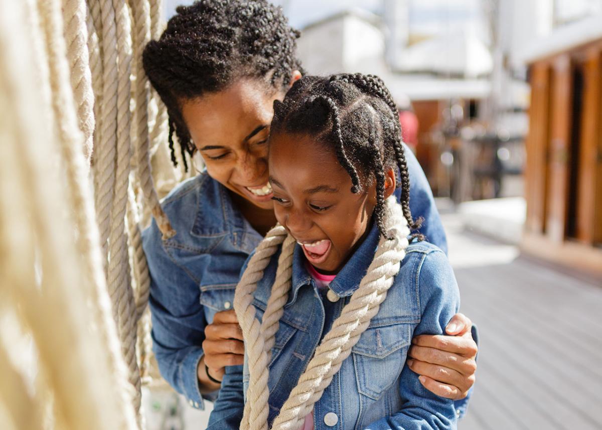 A mum and daughter playing with ropes on the main deck of Cutty Sark