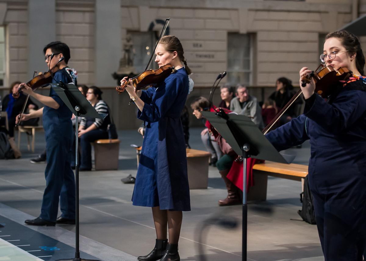 A string ensemble playing in the National Maritime Museum