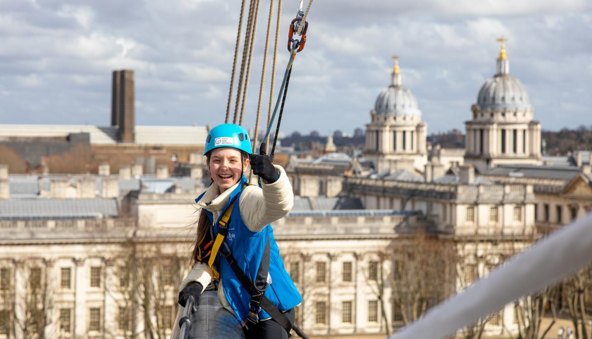 Girl waves from the yard arm of Cutty Sark rigging