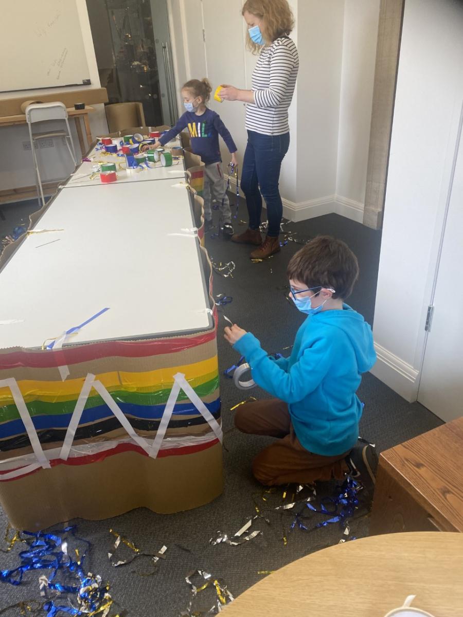 Children creating a rainbow boat