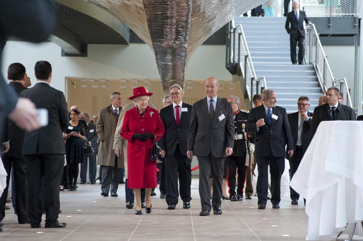 Queen Elizabeth walks beneath the hull of Cutty Sark during the ship's reopening in 2012