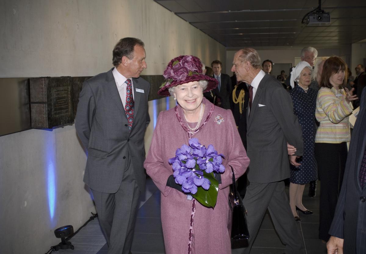 Her Majesty Queen Elizabeth II, wearing a purple suit and hat, visits the Royal Observatory buildings
