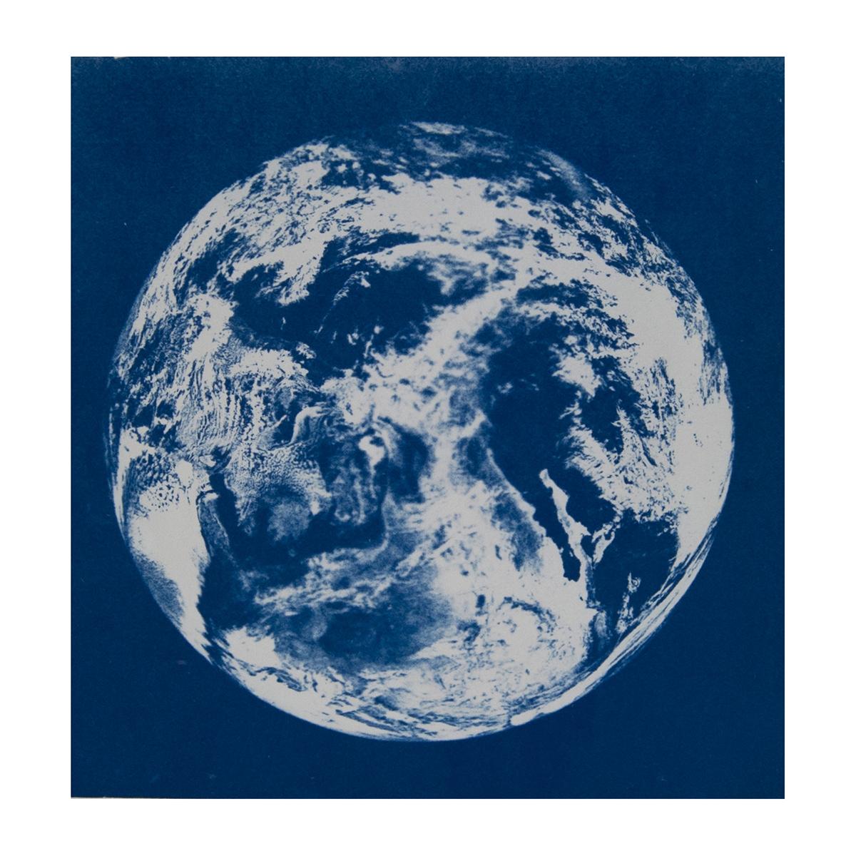 A cyanotype of Earth, appearing in blue and white