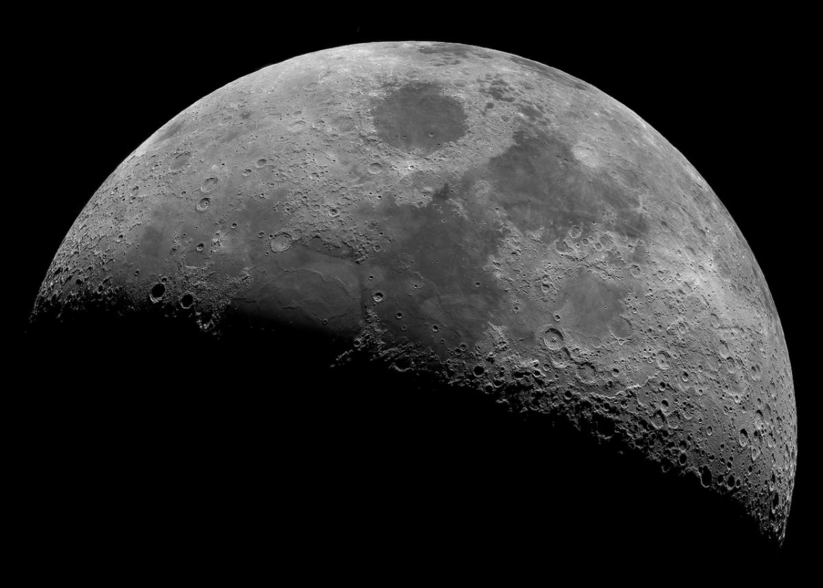 A close up of half of the moon, the other half is in shadow