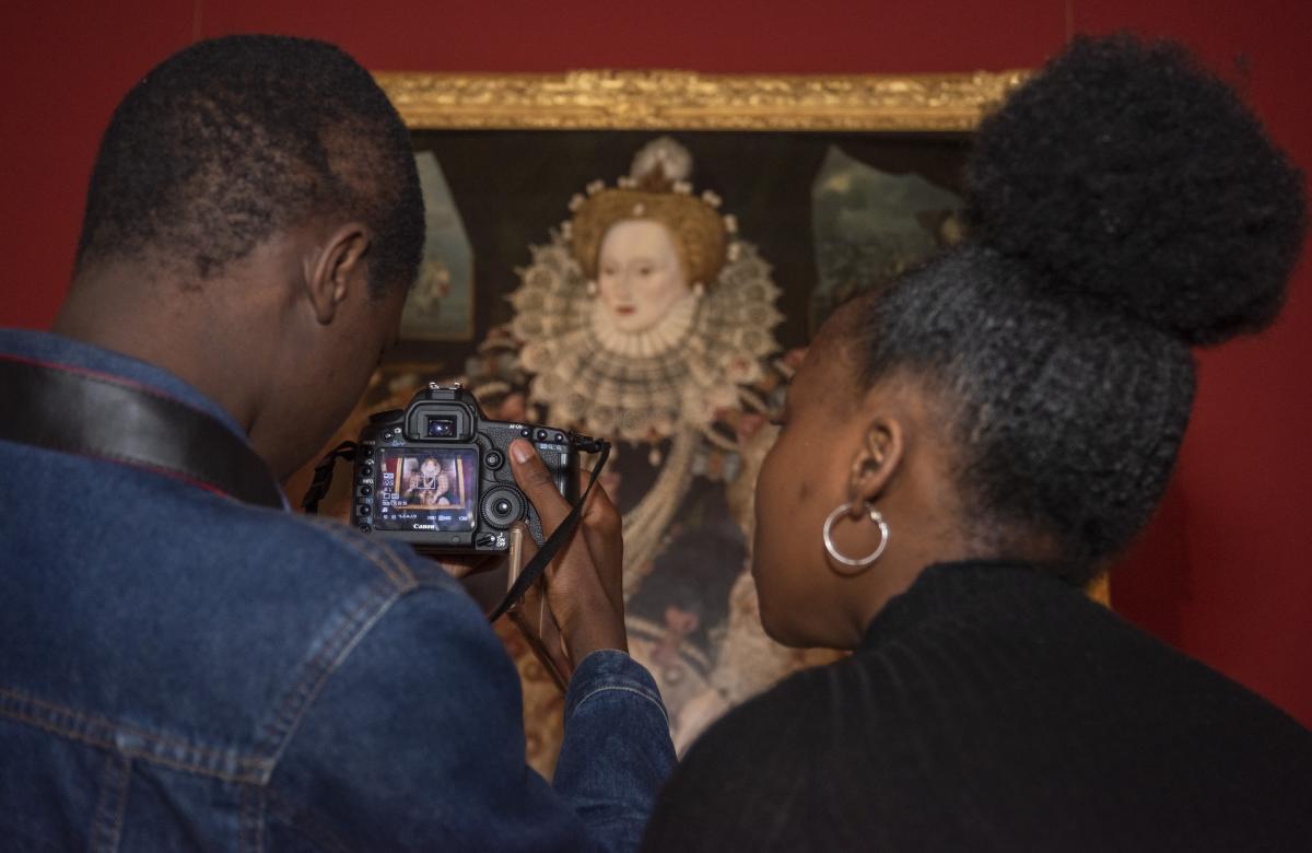 secondary school students look at a painting