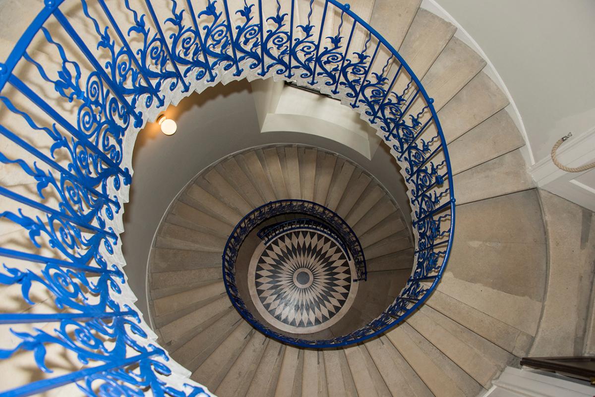 The graceful spiral staircase of the Queen's House, photographed from above and looking down through the open stairwell
