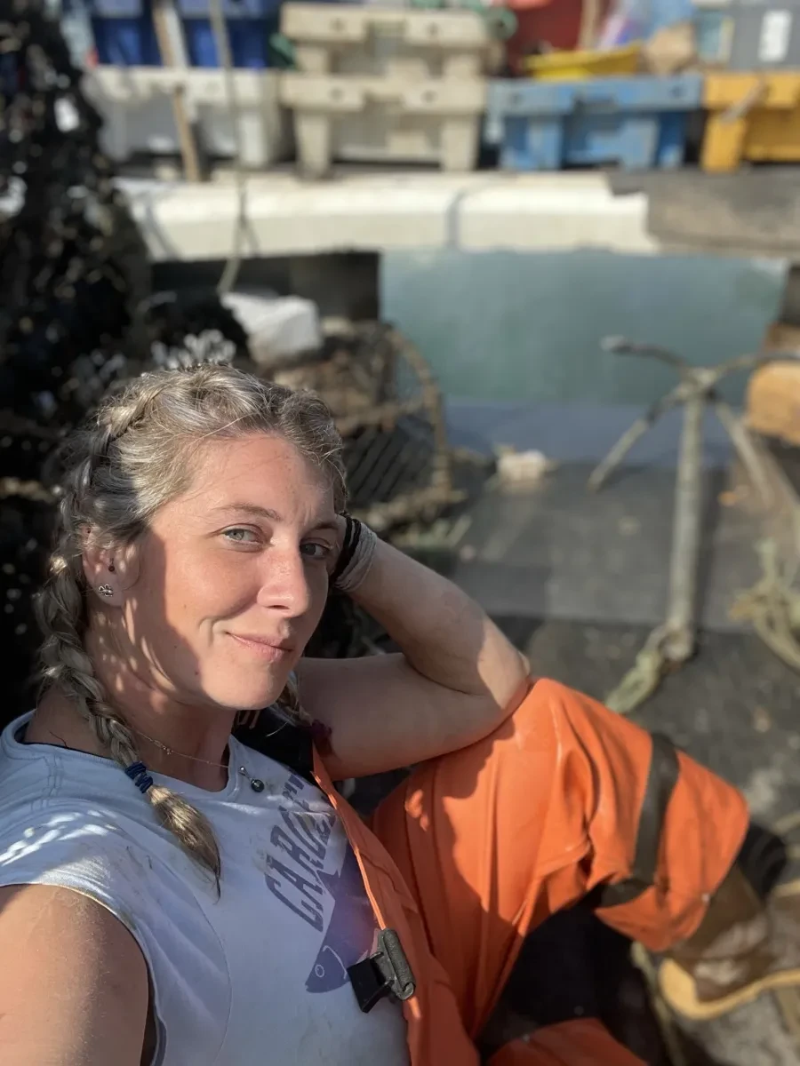 Ashley wearing boiler suit on fishing boat