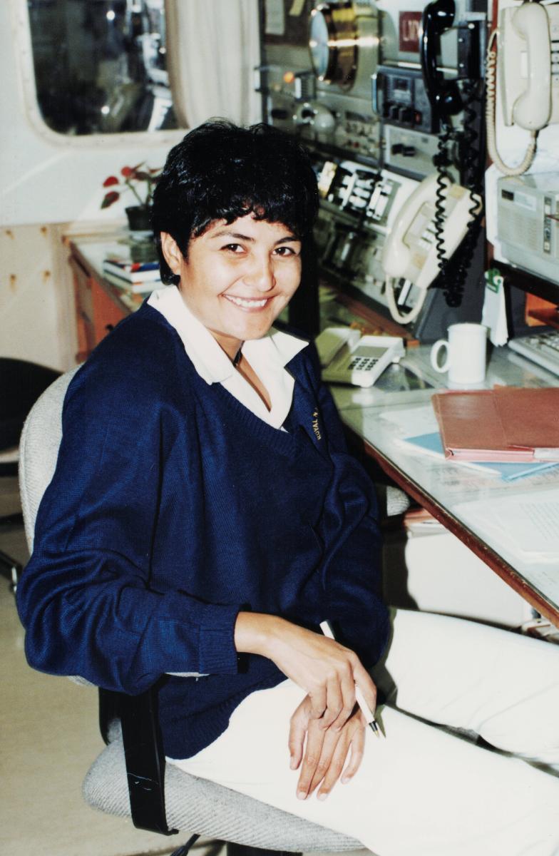 Fazilette Khan sits in front of a radio on a ship