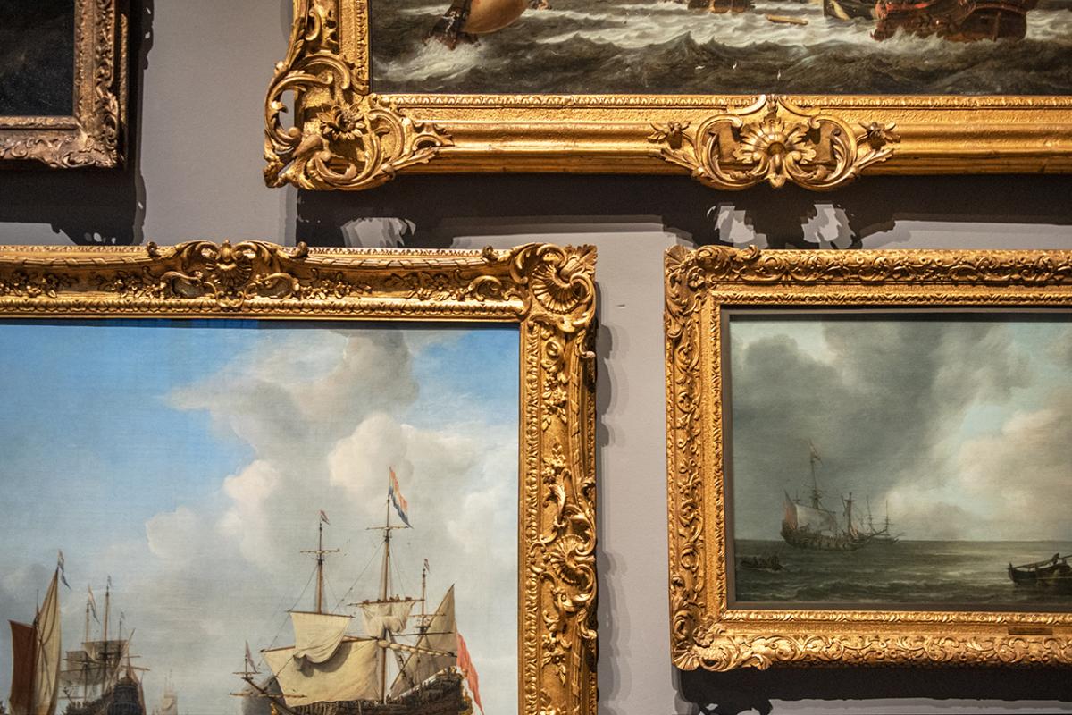 A group of paintings on display at the Queen's House in Greenwich. The image focuses on their burnished gold frames, creating a pleasing geometric pattern on the wall