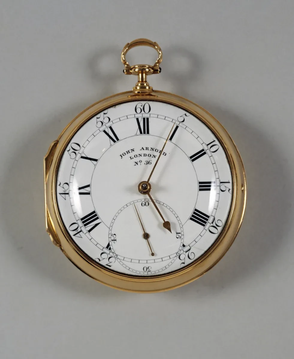 Image of a gold pocket chronometer with crisp lettering and roman numerals
