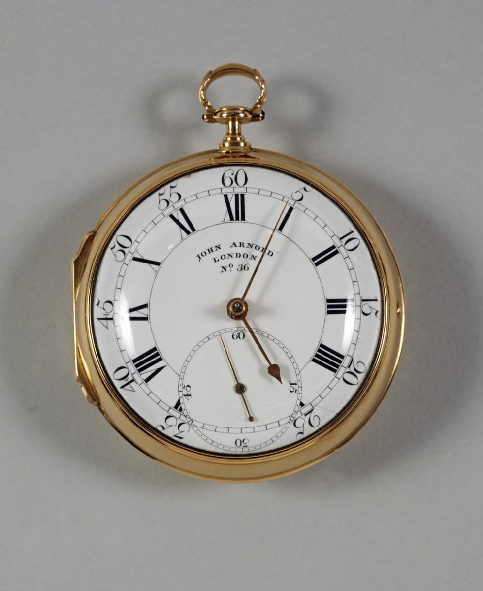 Image of a gold pocket chronometer with crisp lettering and roman numerals
