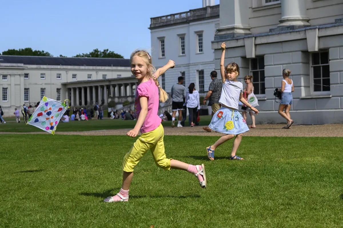 A child flies a kite outside the National Maritime Museum 