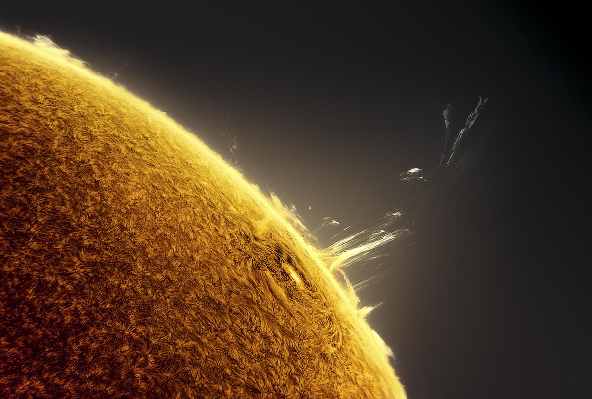 Image showing a solar flare coming out of the sun, looking like steam escaping from the big glowing yellow surface