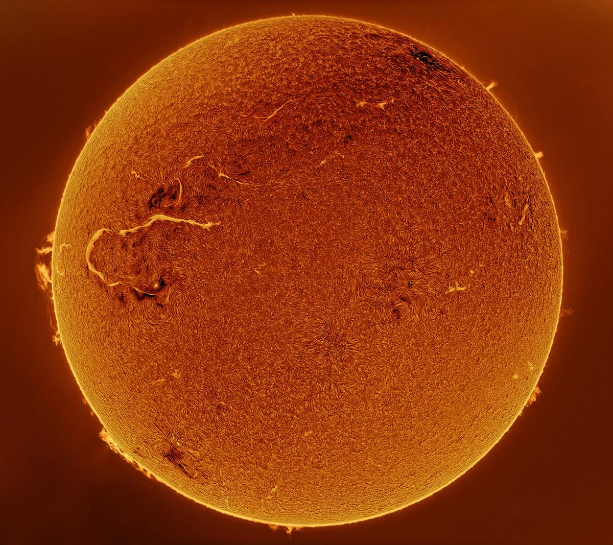 Astronomy photograph of the Sun depicting a big golden ball with orange darker elements