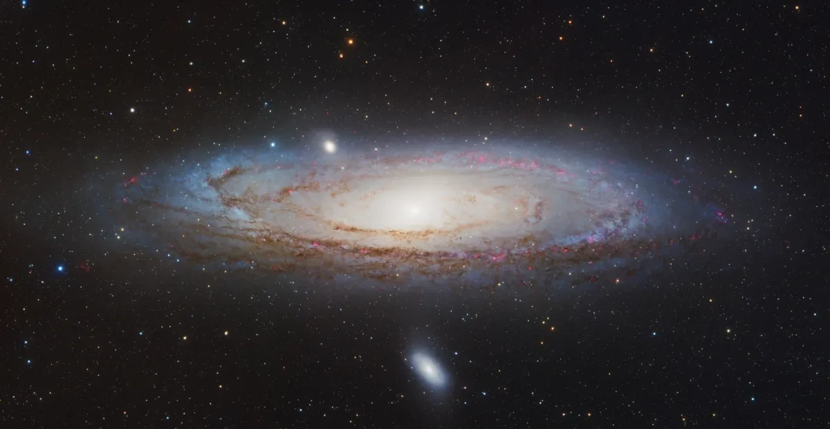 Deep space image showing the Andromeda Galaxy, a vast spiral galaxy appearing as a swirl of stars in the centre of the image