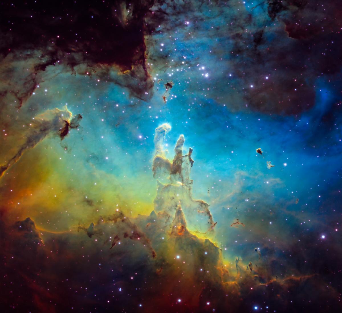 Deep space image showing the core of the Eagle Nebula, appearing as a bright blue and yellow cloud of gas in the centre of a dark sky