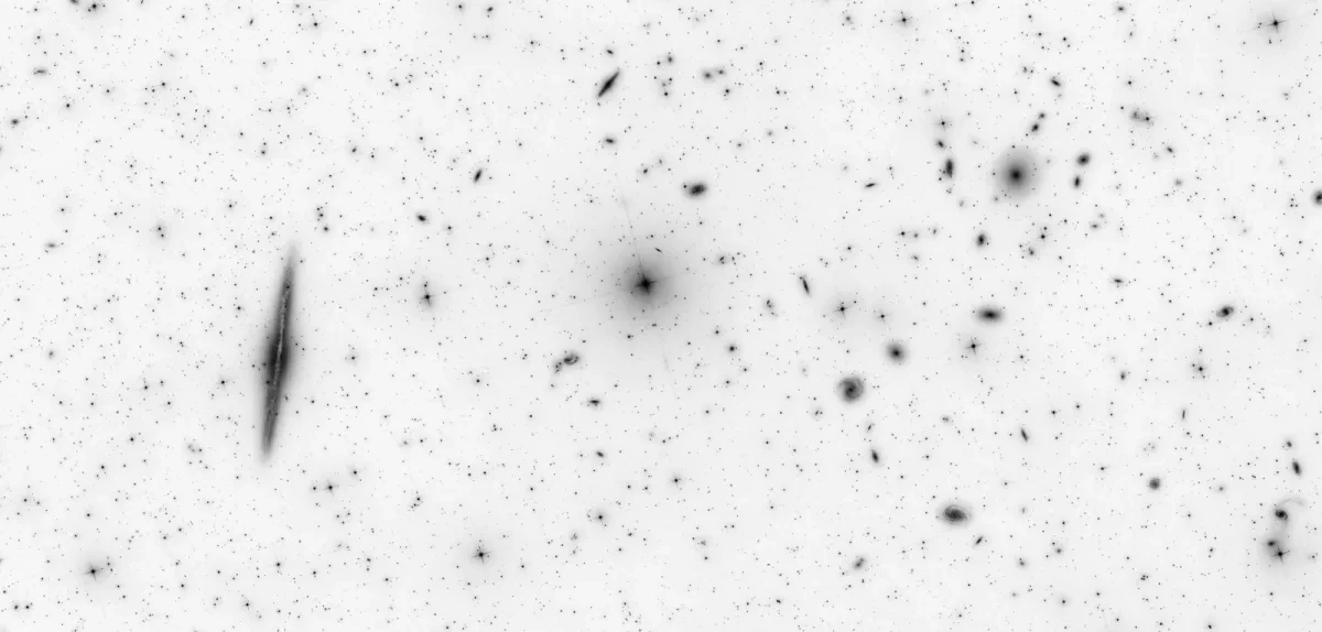 Negative black and white images of galaxies, which look like black drawings on paper