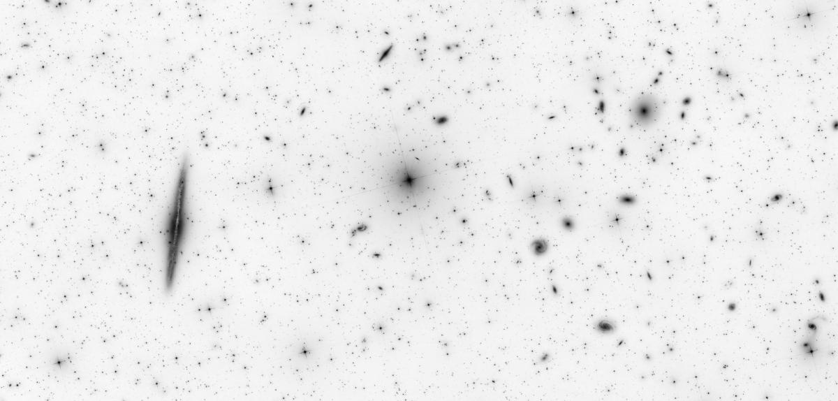 Negative black and white images of galaxies, which look like black drawings on paper