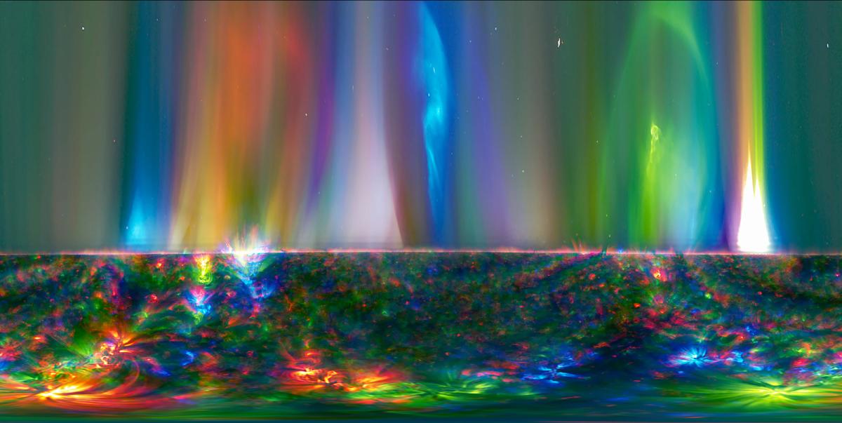 Image showing solar flare from the Sun in all different colours, almost covering the spectrum from greens to blues to oranges, yellows and reds