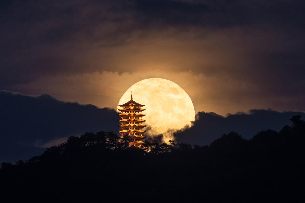 Full Moon rising over an ancient pagoda