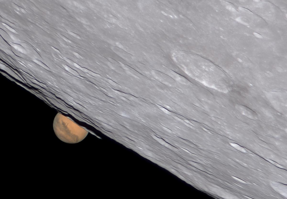 Mars hides behind a section of a full Moom