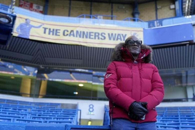 A photo of Paul Canoville standing in the seating area of a stadium