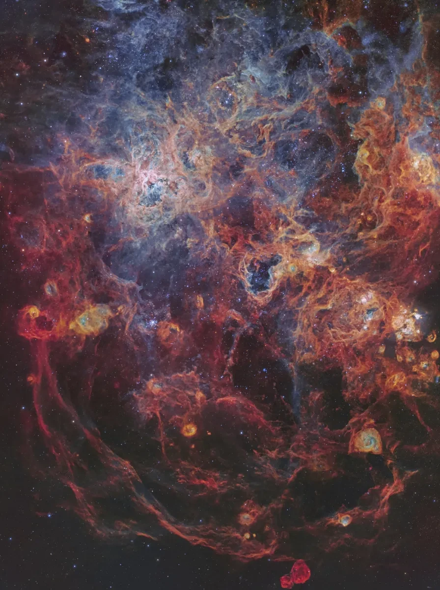 Image showing nebulae in tones of blues, oranges and reds which resembles a kind of spider web