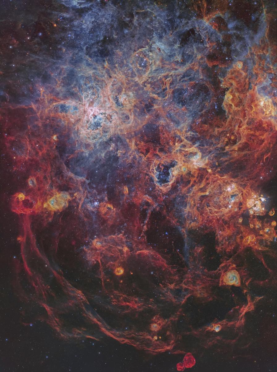 Image showing nebulae in tones of blues, oranges and reds which resembles a kind of spider web