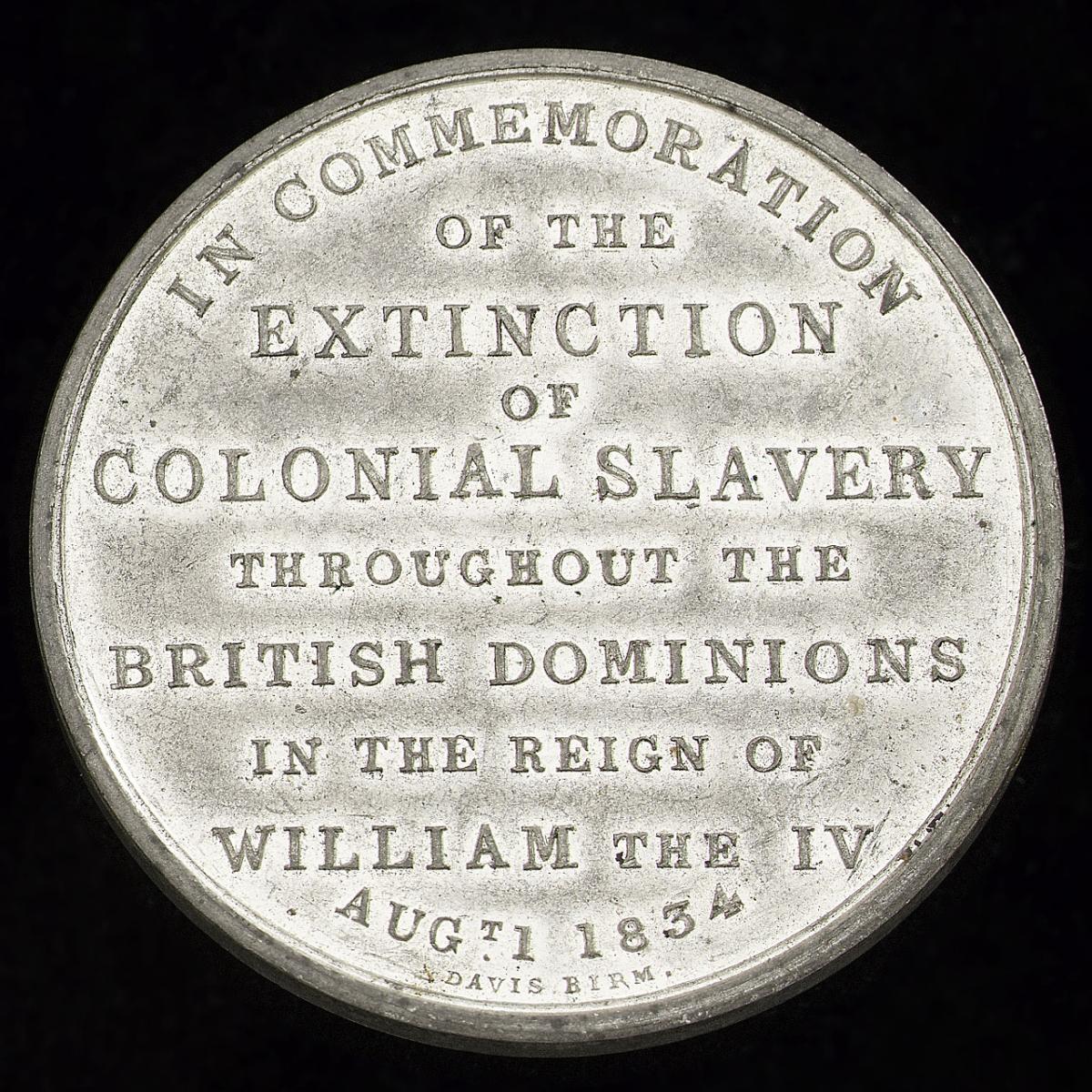 A silver medal commemorating the abolition of slavery. The embossed words read: 'In commemoration of the extinction of colonial slavery throughout the British dominions in the reign of William the IV - Aug 1 1834'