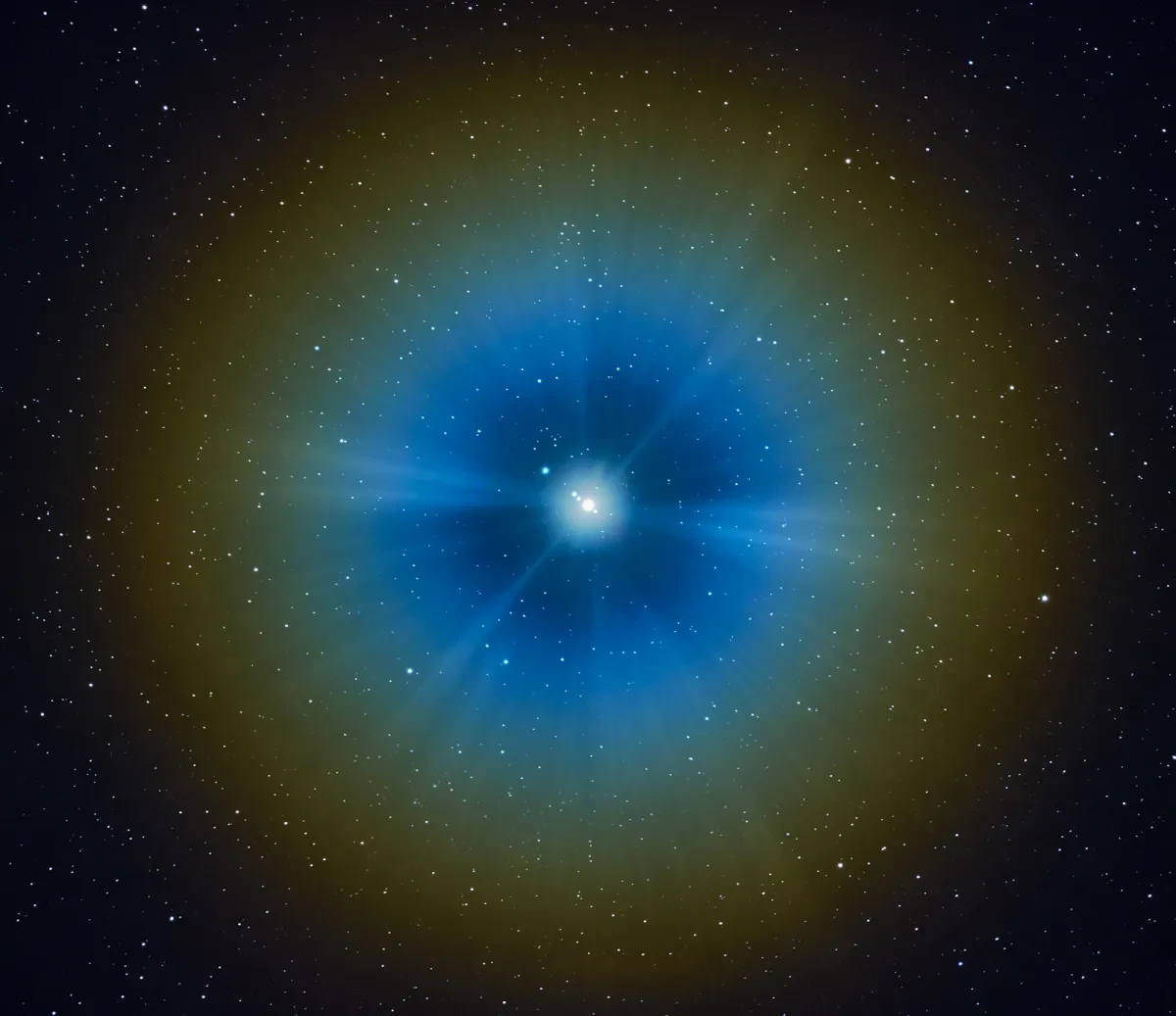 Photograph of Jupiter taken from Earth. The planet appears right at the centre of the image, with a hazy blue light causes by mist ringed around