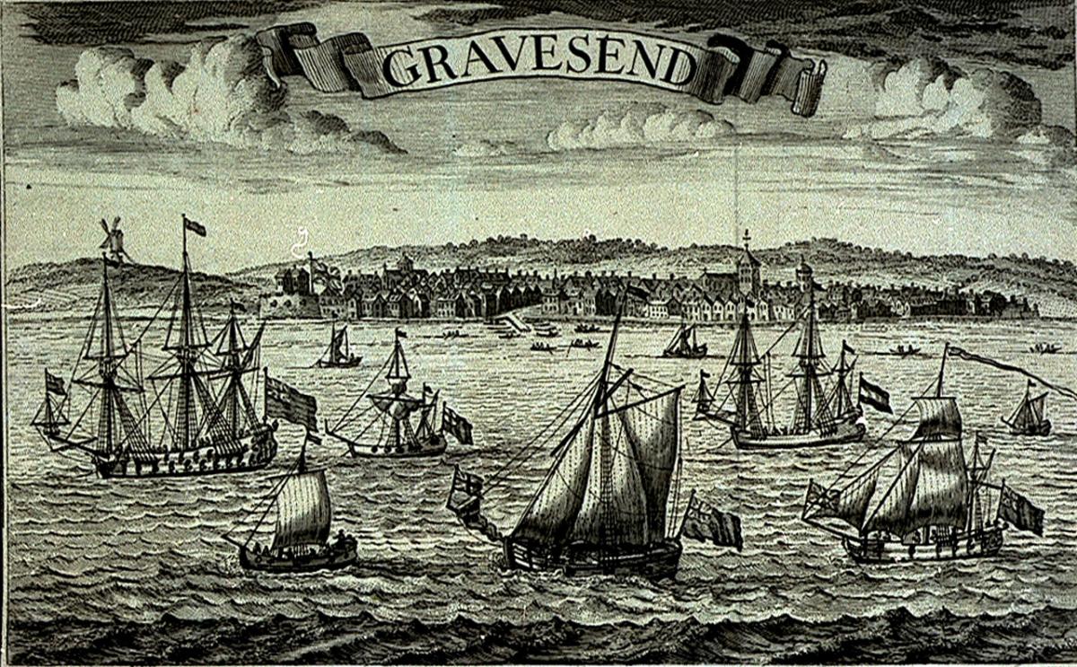 Historic black and white print of Gravesend. The view is taken from out to sea looking back at the coastal town, with ships and small boats in the foreground. A banner announcing the place as 'Gravesend' takes the form of a scroll across the top