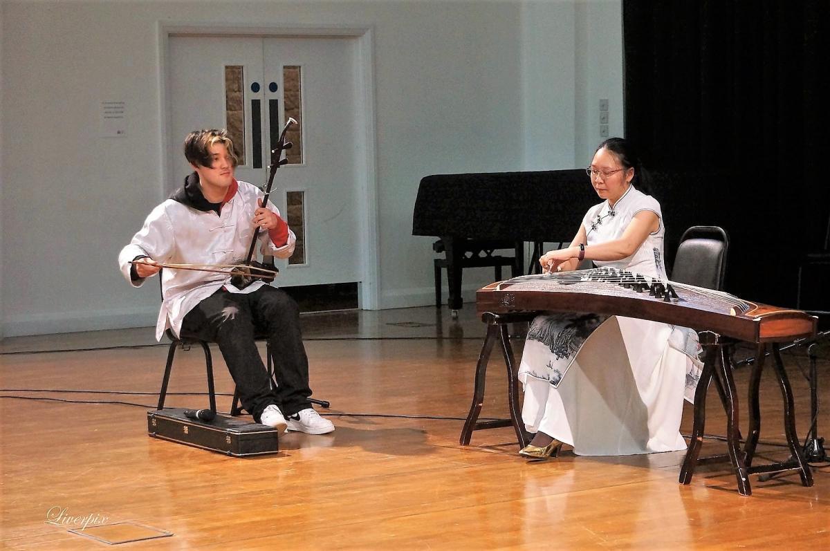 Pagoda arts performing in a hall on traditional East Asian instruments