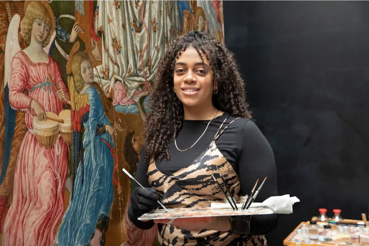 A photo of Kendall Francis in front of a painting