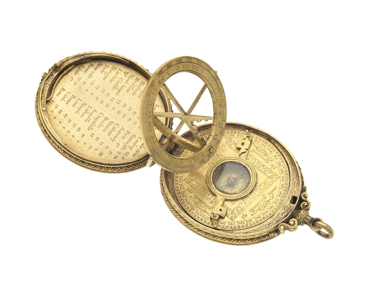 A golden oval shaped astronomical instrument is open to reveal a compass