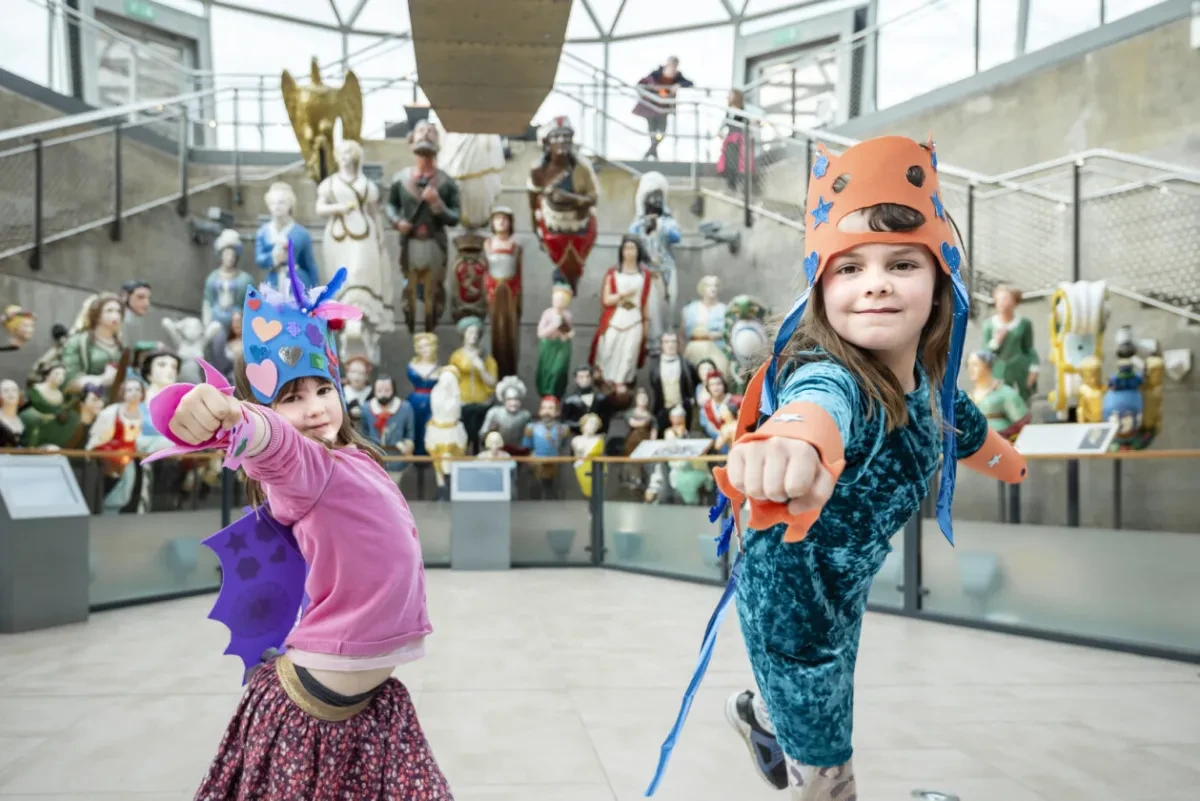 Two children with paper colorful masks