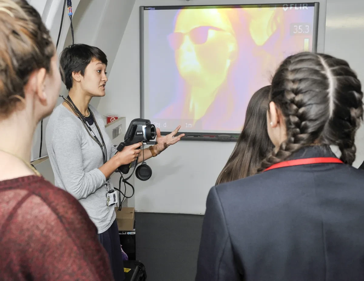 A teacher demonstrates a special type of video camera to students