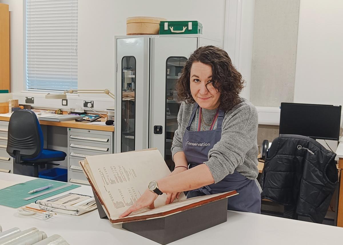 A museum conservator working on a book for display