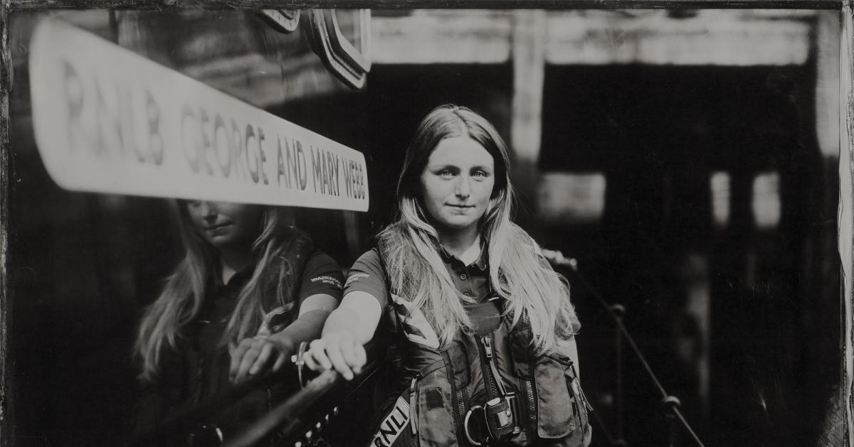Black and white image of a woman wearing RNLI gear
