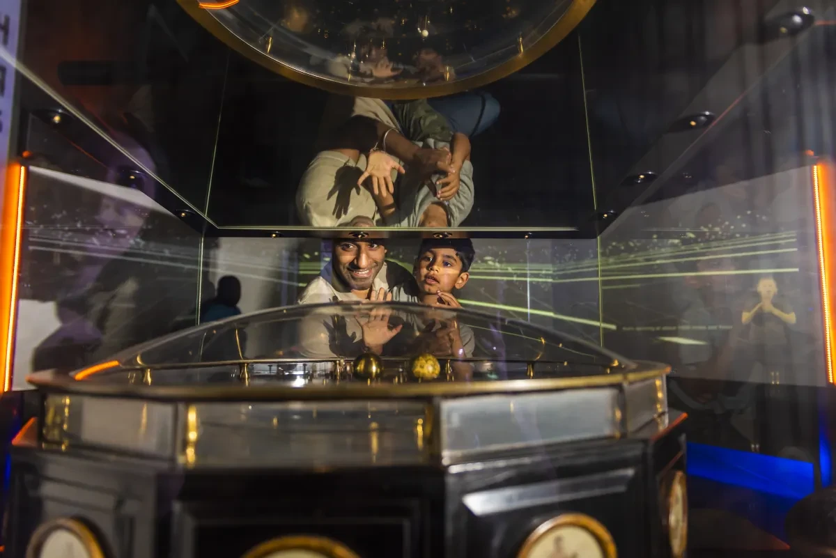 A parent and child look at navigational instruments in the Royal Observatory