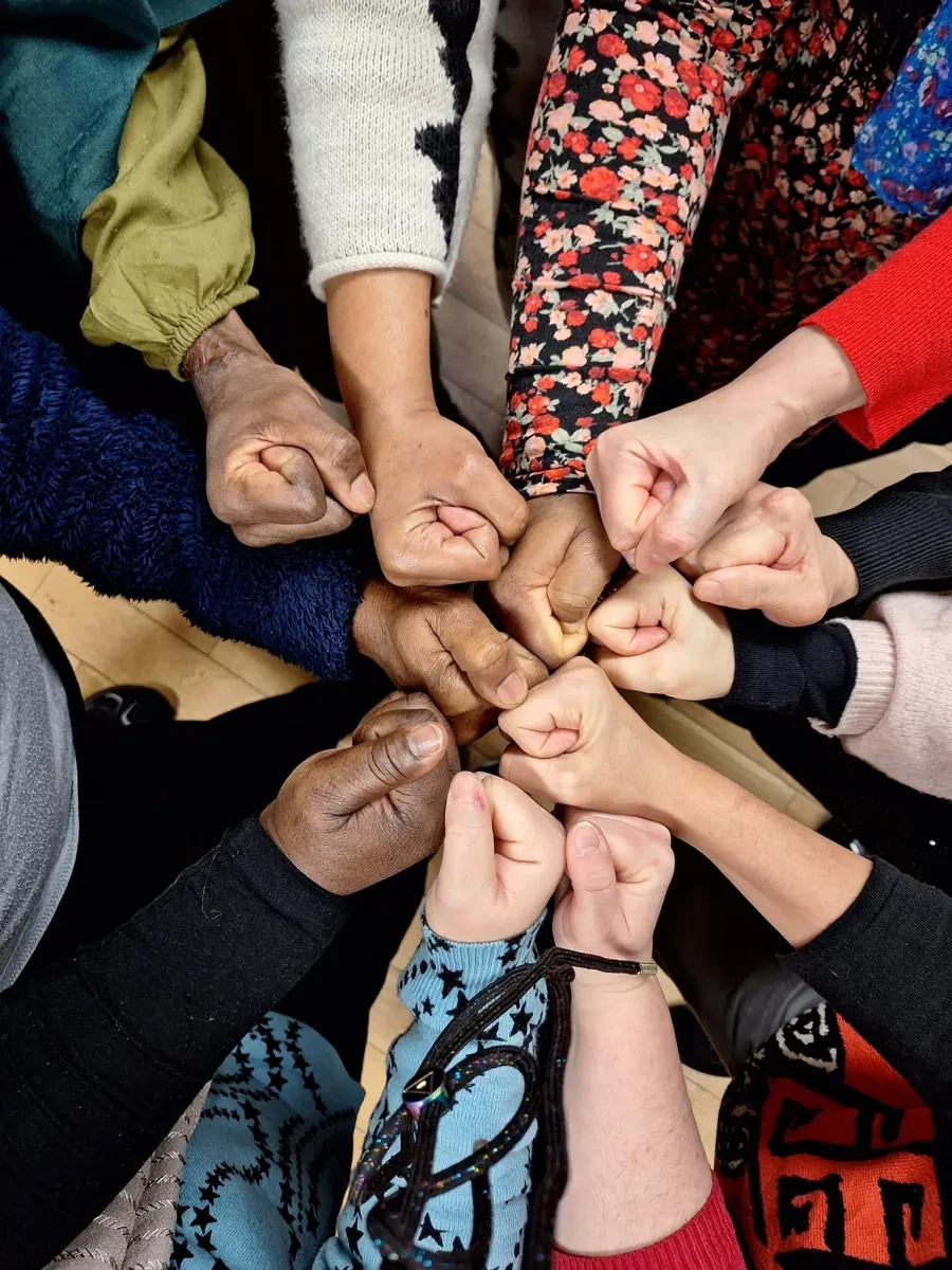 photo of ten 10 hands in a fist touching